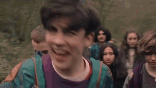 a man is screaming in a crowd of people .
