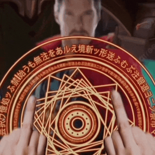 a man is holding a magical circle in his hands with foreign writing on it .