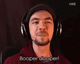 a man wearing headphones and a hat says booper dooper .
