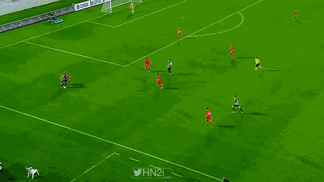 a soccer game is being played on a field that has qnb written on the sidelines