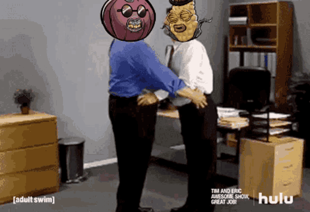 two men are hugging each other in an office with a hulu logo in the background
