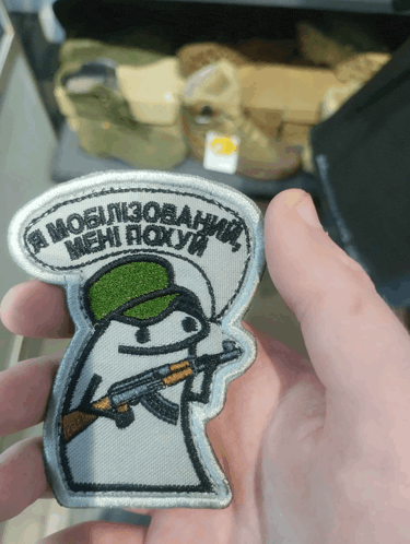 a person holding a patch that says " a mobilization "