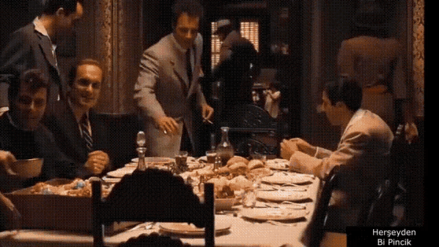 a group of men are sitting at a table with the words herseyden bi pincik on the bottom right