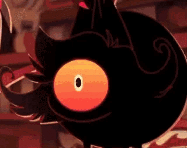 a close up of a cartoon character with a red eye and a black body .