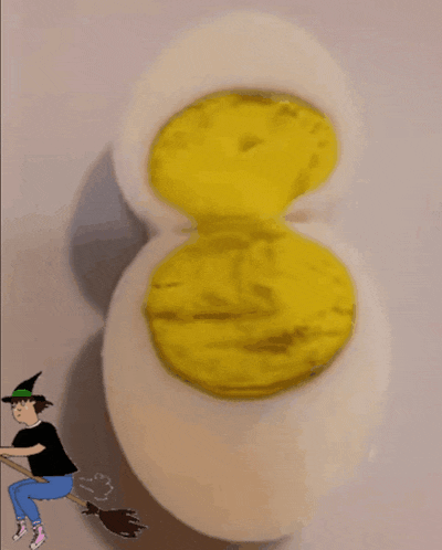 a cartoon of a witch riding a broom next to an egg