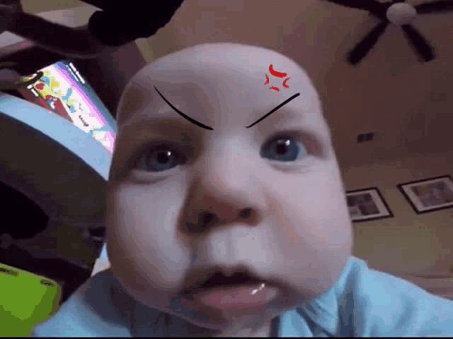 a baby with a red arrow on his forehead