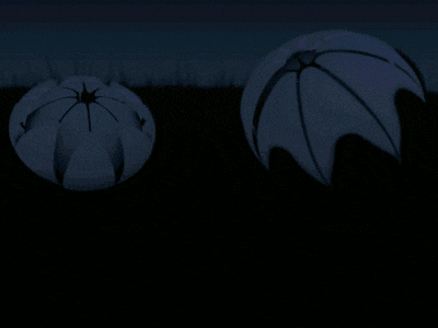 two pink balls in a field with a dark background