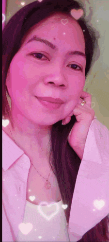 a woman in a pink shirt with hearts on her face