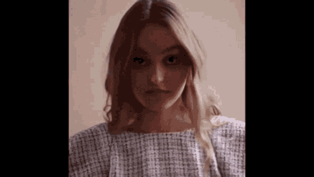 a close up of a woman 's face in a white dress .