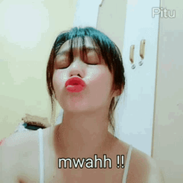 a woman making a funny face with the words mwahh written on the bottom