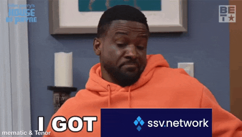 a man wearing an orange hoodie is holding a sign that says i got