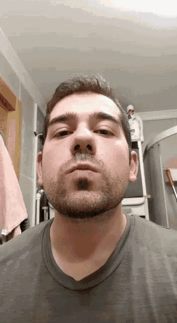 a man with a beard looks at the camera