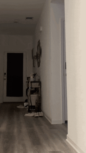 a dark hallway with a table and a mirror