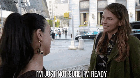 two women are talking on a street and one of them is saying i 'm just not sure i 'm ready .
