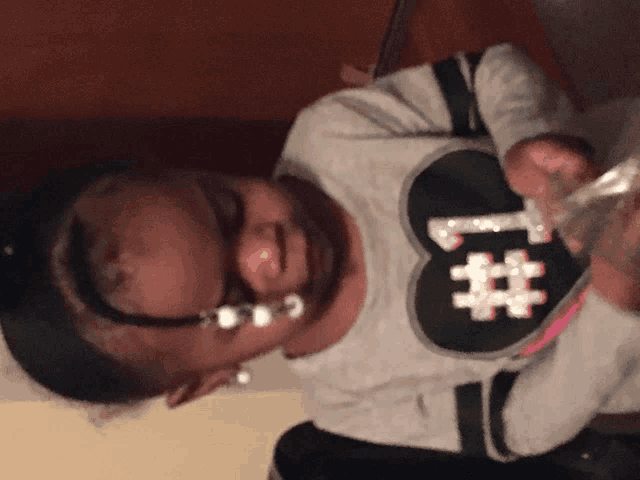 a little girl wearing a shirt that says # 1 on it