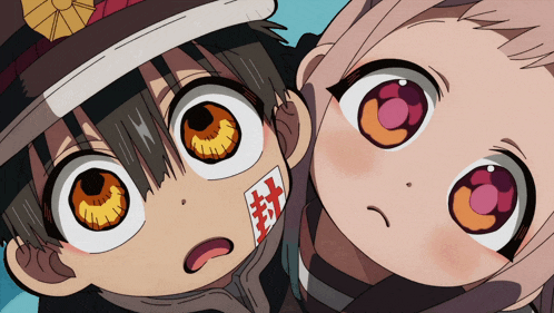 a boy and a girl are looking up at the camera