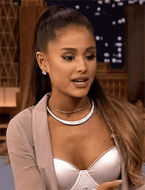 a close up of a woman wearing a bra and a choker