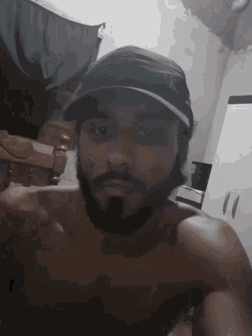 a shirtless man with a beard wearing a hat that says ny on it