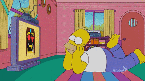 homer simpson laying on the floor watching a game on a television