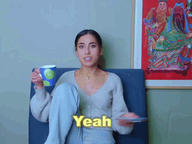a woman is sitting in a chair with her legs crossed and the word yeah written in yellow