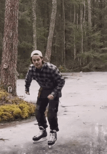a man in a plaid shirt is ice skating