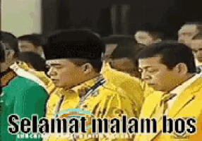 a group of men in yellow suits are standing in a line with the words selamat malam bos above them
