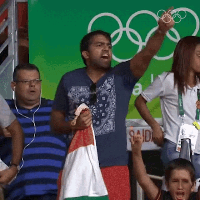 a man holding a flag in front of a sign that says said