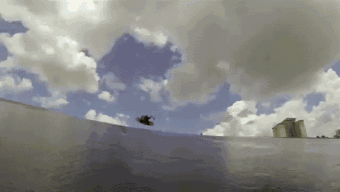 a skateboarder is doing a trick on a ramp with a cloudy sky in the background