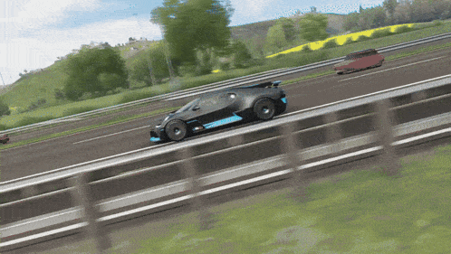 a black car with a blue stripe on the side is driving down a road