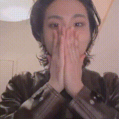 a woman is covering her face with her hands in prayer .