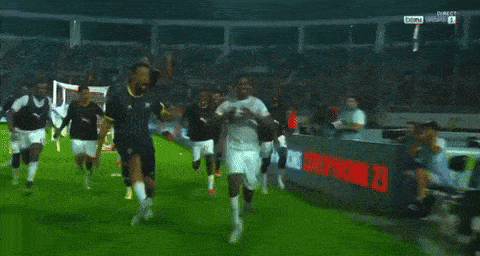 a group of soccer players are celebrating on a field with being written on the bottom of the screen