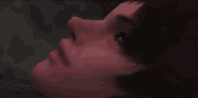a close up of a person 's face with a red glow