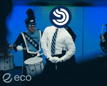 a man playing drums in a marching band with a logo on his head that says eco