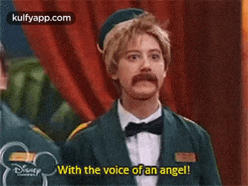 a man with a mustache is wearing a tuxedo and bow tie and saying `` with the voice of an angel ! ''