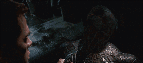 a man with a mask on his face is looking at another man