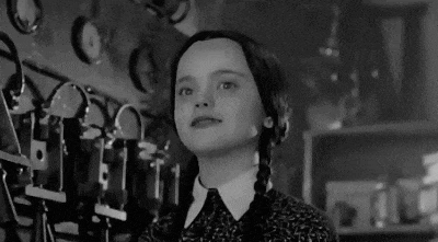 a black and white photo of a young girl in a costume .