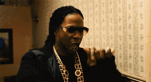 a man wearing sunglasses and a necklace that says pop