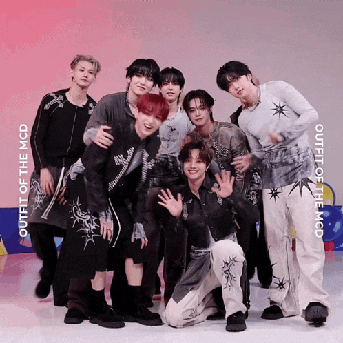 a group of young men are posing for a picture with the words outfit of the mcd behind them