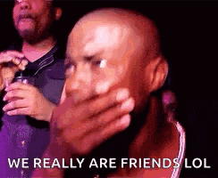 a bald man is covering his mouth with his hand and says `` we really are friends lol ''