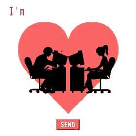 a man and a woman are sitting in front of computer monitors in front of a heart
