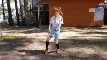 a girl with red hair is standing in front of a building