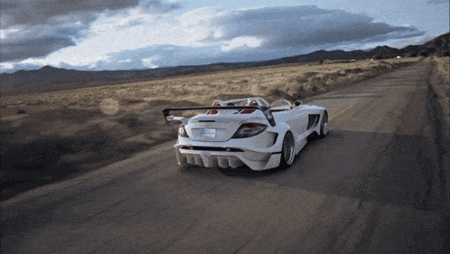 a white sports car with a license plate that says california on it