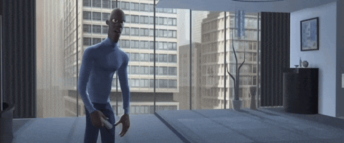 a man in a blue shirt is standing in a room with a large window