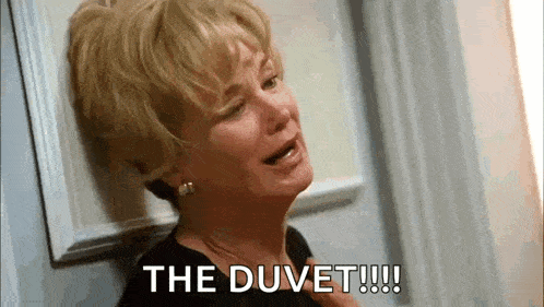 a woman is crying while leaning against a wall and saying `` the duvet !!! '' .