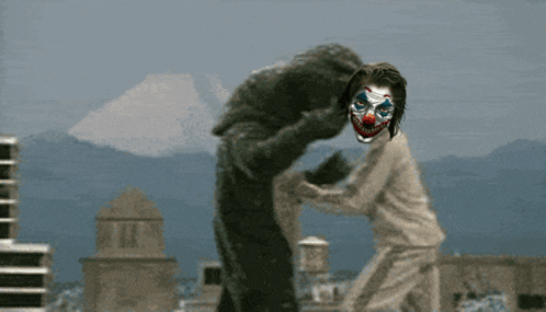 a man in a clown mask is holding a woman in a white shirt