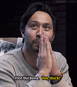 a man covering his mouth with his hands and says plot thickens yes thick