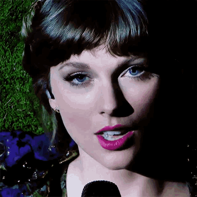 a close up of a woman 's face with purple lipstick