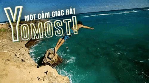 a man jumps off a cliff into the ocean with yomost written on the bottom