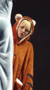 a woman in a tiger costume is standing next to a man in a blue shirt