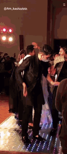 a group of people dancing on a dance floor with a caption that says @am_kashishhh